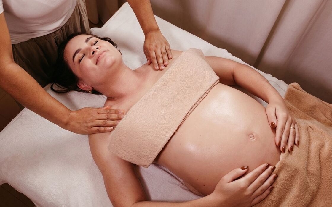 Prenatal massage — expectant mother relaxing on a massage table